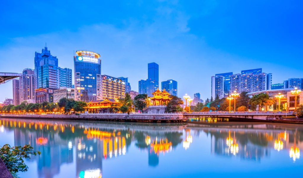 Chengdu city lights reflected in the river at dusk