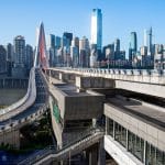 A cable-stayed bridge crossing into central Chongqing with the CBD skyline behind it, morning light