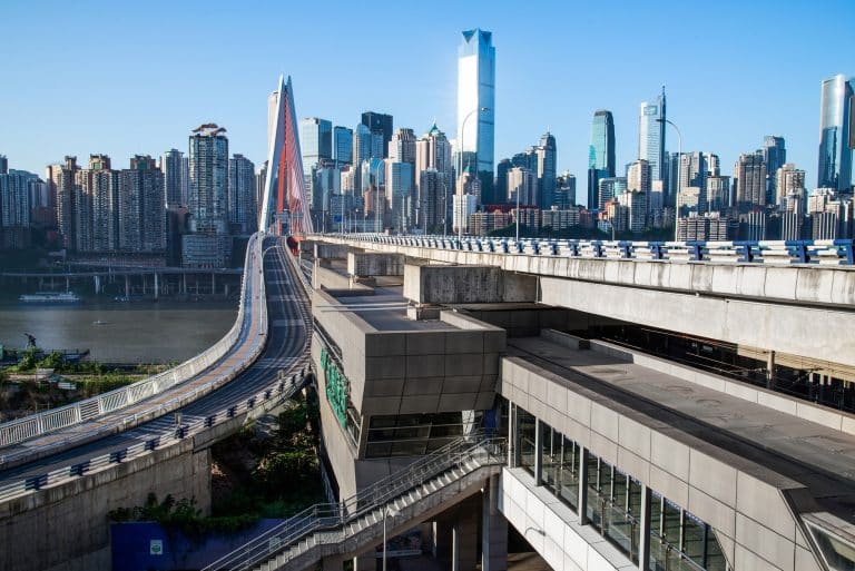 A cable-stayed bridge crossing into central Chongqing with the CBD skyline behind it, morning light