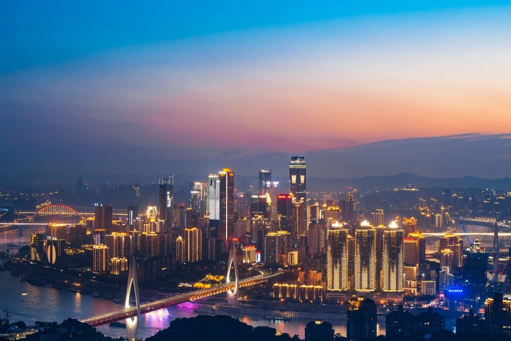Chongqing skyline at dusk from the Yangtze-Jialing confluence, bridges and towers lit up