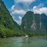 A tourist cruise boat on the Li River below the karst peaks between Guilin and Yangshuo