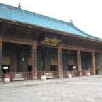 The prayer hall of the Great Mosque of Xi'an, with its turquoise-tiled roof and Arabic calligraphy sign