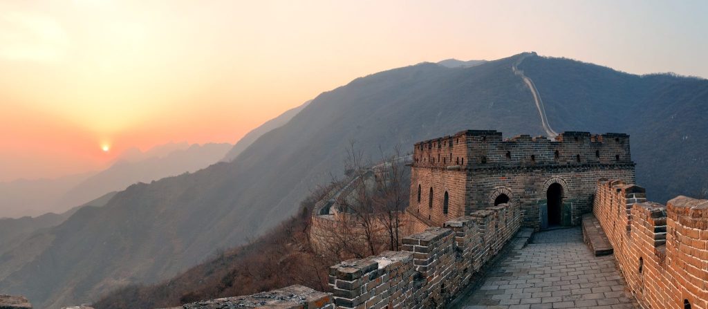 A watchtower on the Great Wall of China at sunset in the mountains near Beijing