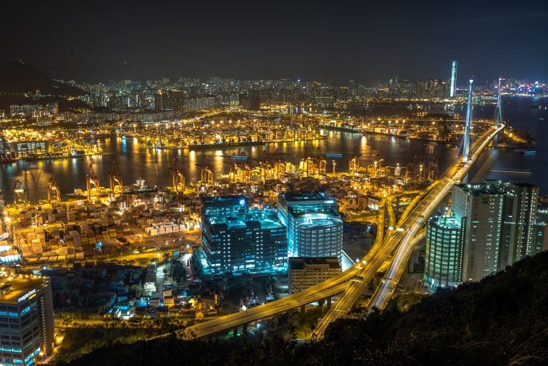 Hong Kong Victoria Harbour skyline lit up at night, seen from the waterfront