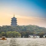 Leifeng Pagoda rising above the trees on the south shore of West Lake, Hangzhou, seen across the water at dusk
