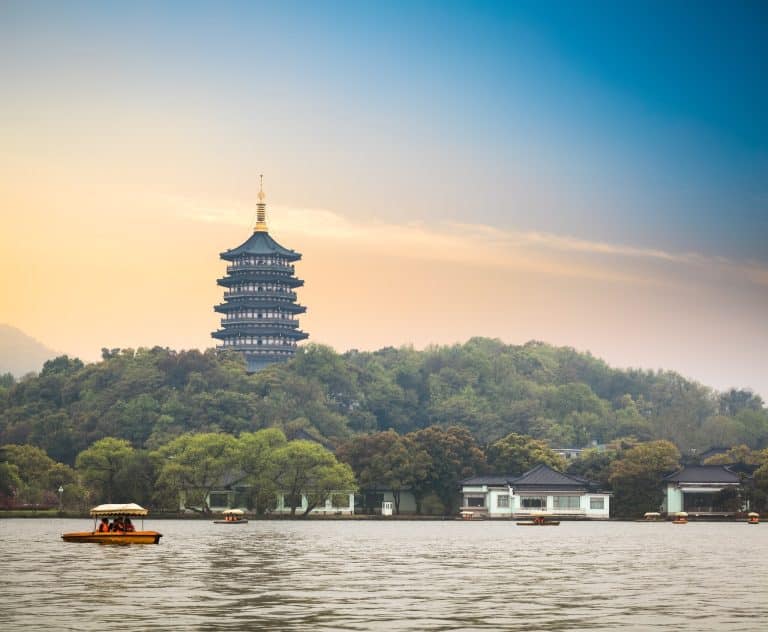 Leifeng Pagoda rising above the trees on the south shore of West Lake, Hangzhou, seen across the water at dusk