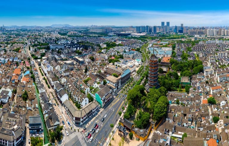 Aerial view of North Temple Pagoda rising above the old town rooftops of Suzhou