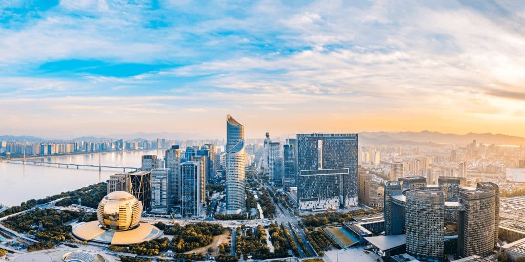 Qianjiang New Town skyline in Hangzhou at sunset, with the golden dome of the Hangzhou International Conference Center and the city's financial district towers