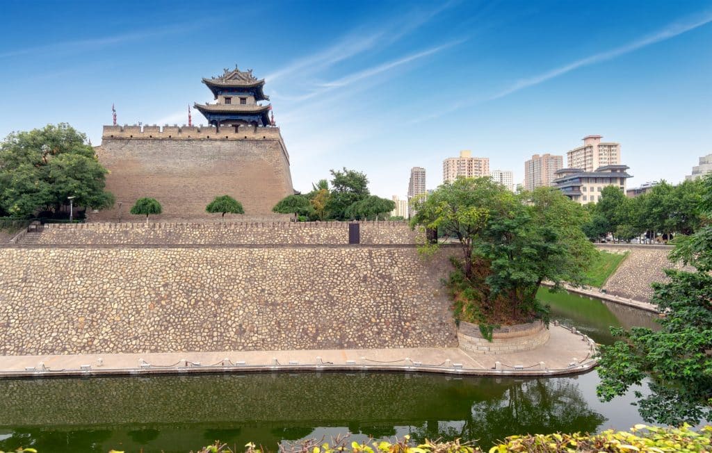 Corner watchtower of the Xi'an City Wall, with the moat below and the modern skyline behind