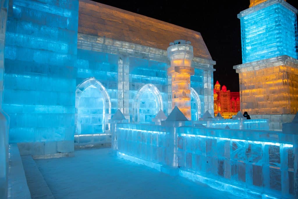 Illuminated ice buildings at night during the Harbin International Ice and Snow Festival, China