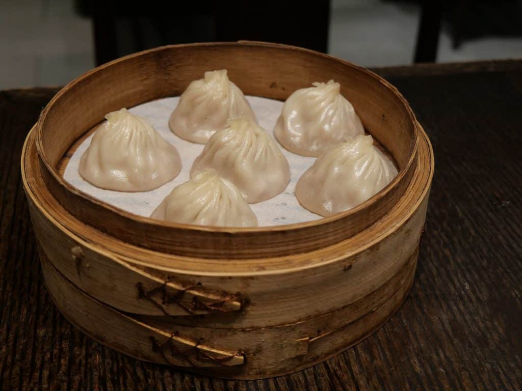 Xiaolongbao soup dumplings in a bamboo steamer basket