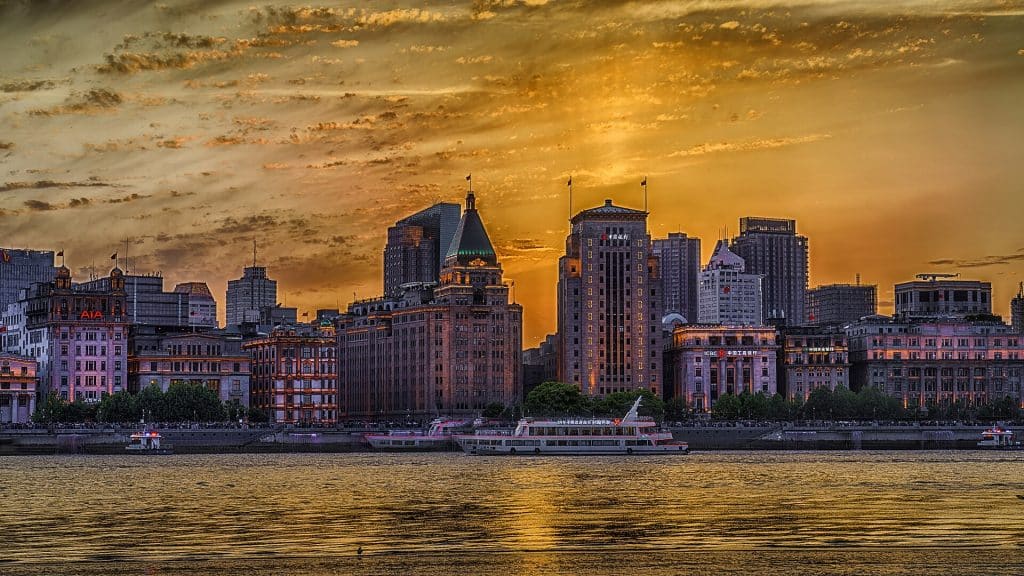 The Bund waterfront buildings in Puxi at sunset, seen across the Huangpu River, Shanghai
